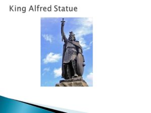 Photograph of a statue of King Alfred holding a sword against a blue sky